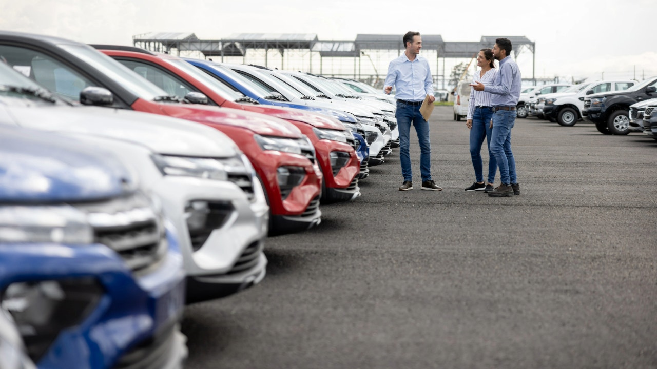 car salesman dealership istock