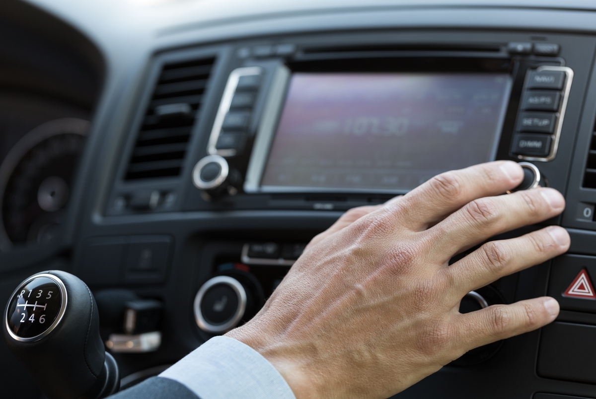 hand on car entertainment system