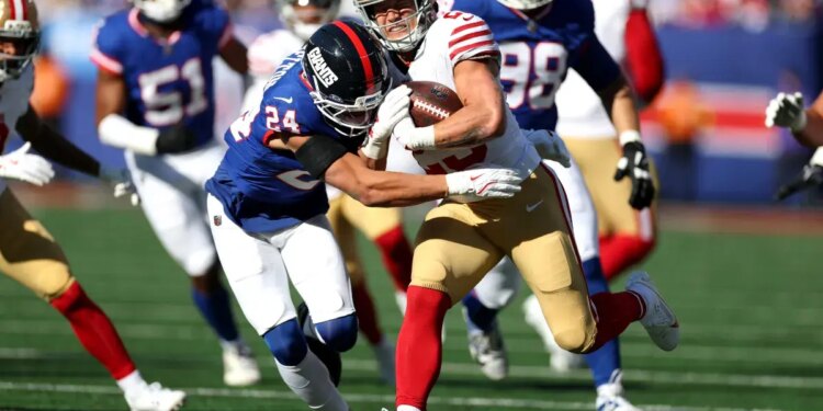 Christian McCaffrey was hit with a trip against the New York Giants.